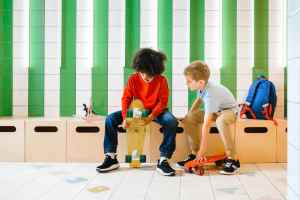 Two kids messing with skateboards