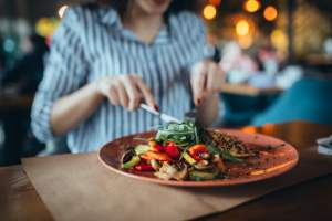 Woman eating salad at a restaurant