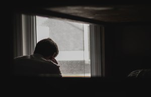 Man in front of window.