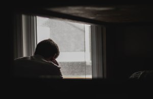 man in front of window