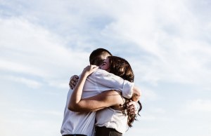 man and woman hugging