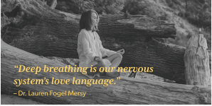 Woman meditating on rocks behind quote: "Deep breathing is our nervous system's love language."