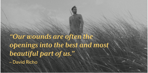 Man walking through a field behind quote: "Our wounds are often the openings into the best and most beautiful part of us."