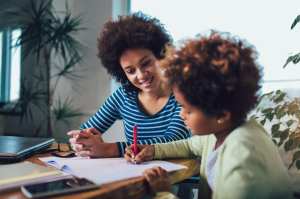 Woman helping a child with homework