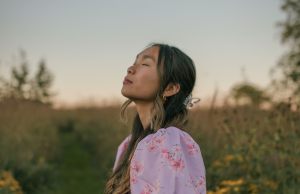 Woman in pink standing in a field