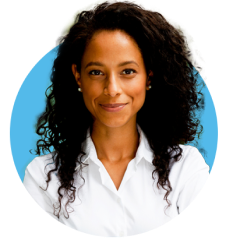 Woman with black curly hair and white shirt looking straight forward and grinning.