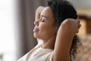 Woman leaned back with hands behind her head