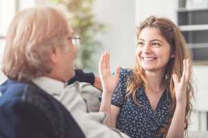 Daughter speaking animatedly with her father