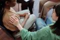 Woman comforting another person in a support group