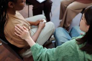 Woman comforting another person in a support group